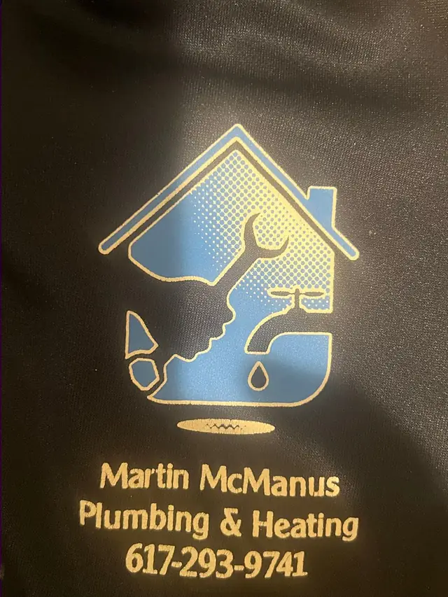 Close-up of the Martin McManus Plumbing & Heating logo and phone number printed on a crew hoodie