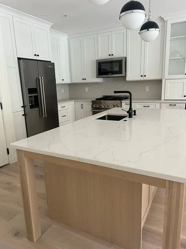 The same island kitchen from a different angle, sink and faucet finished and ready for use